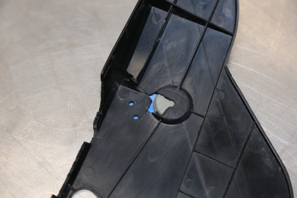 backside of a damage plastic automotive trim panel