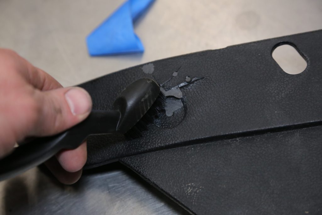 using a detail brush on a damage automotive trim panel