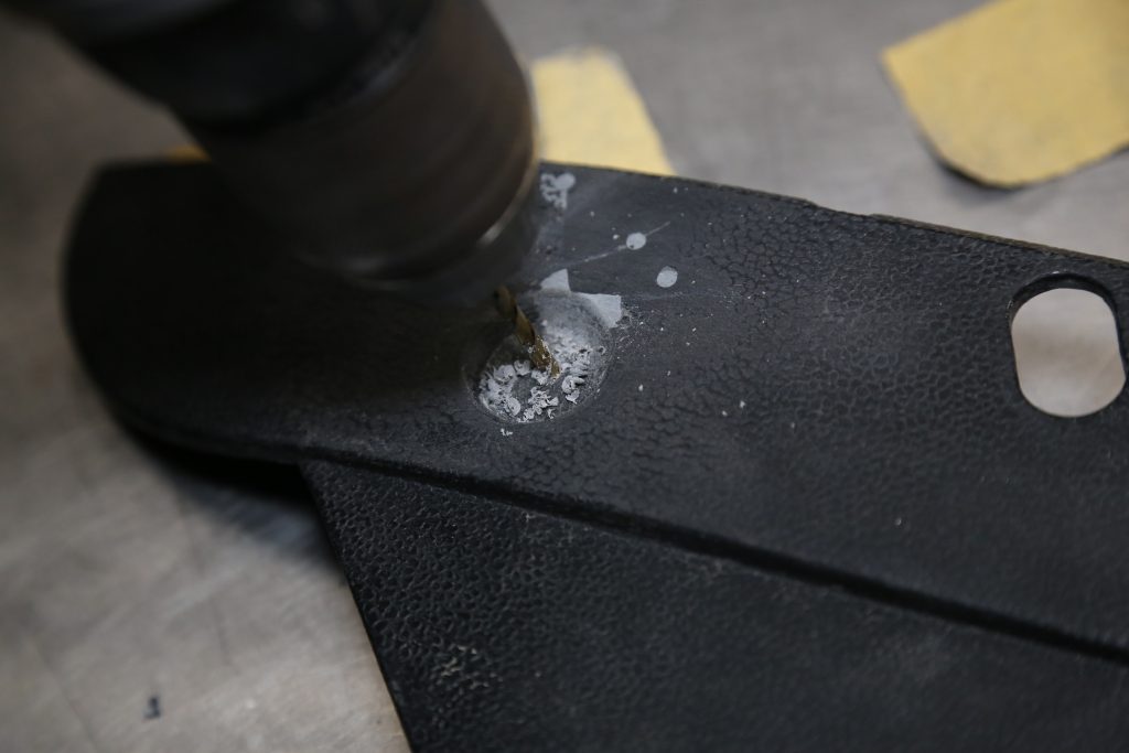 drilling a hole in a damage automotive trim panel