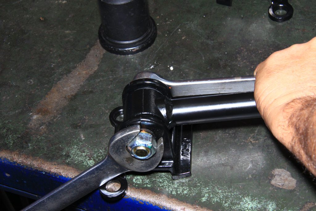 tightening down a mounting bolt on a workbench