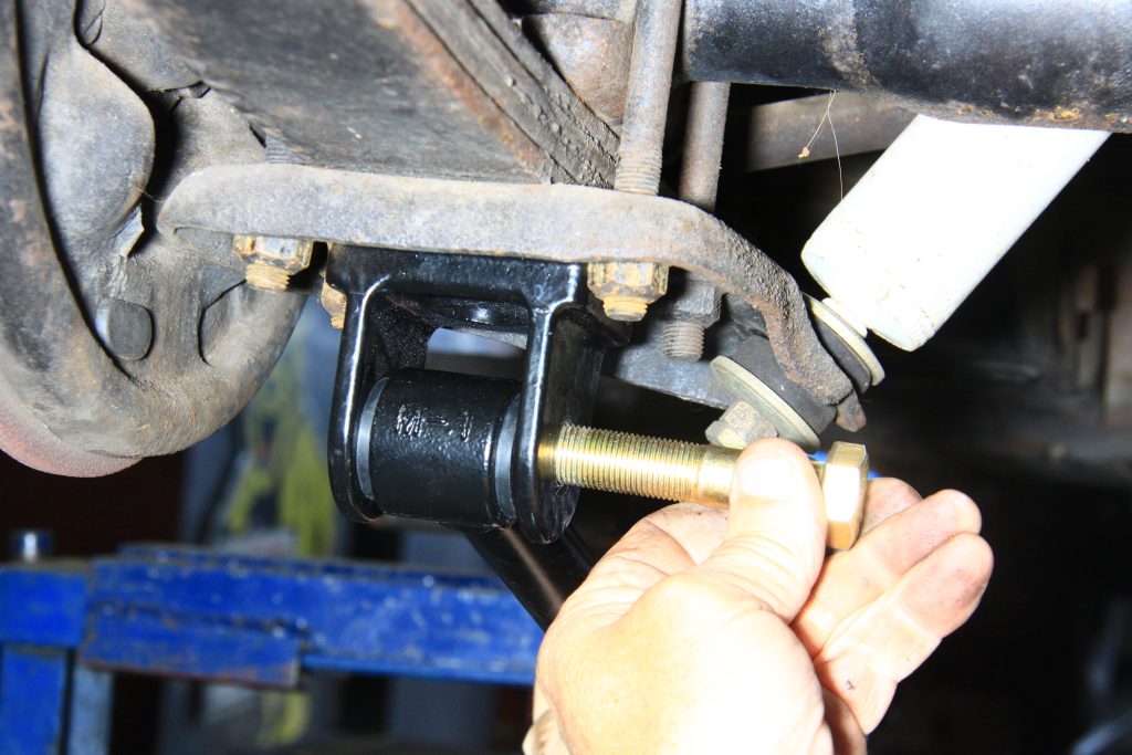 inserting bolt into a traction bar mount