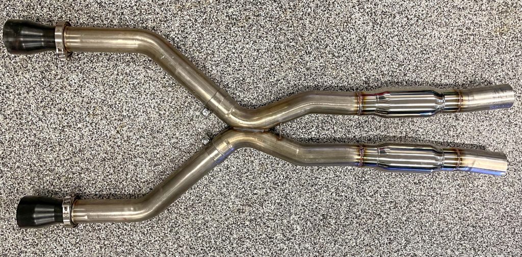 a muscle car exhaust system on garage floor