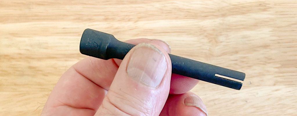 man holding a metal zip tie tightening tools