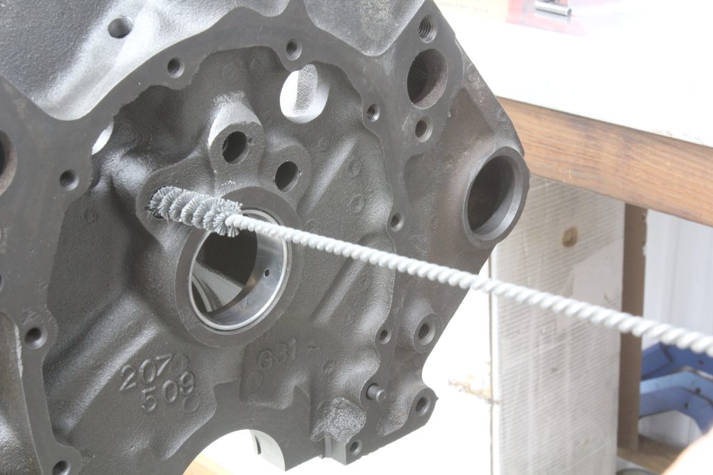 using a brush to clean engine bores and holes