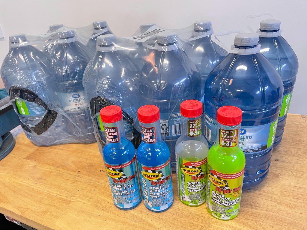 jugs of coolant flush and distilled water