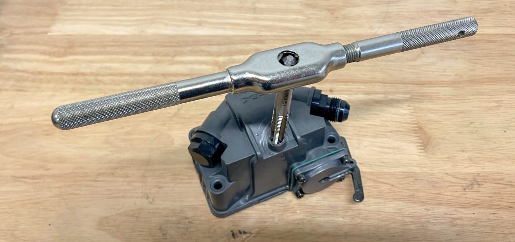 thread tap repairing thread in a fuel port