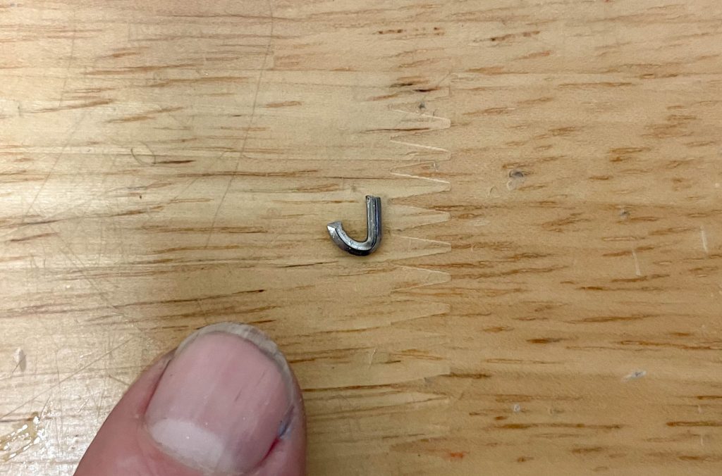 tiny piece of removed thread repair insert