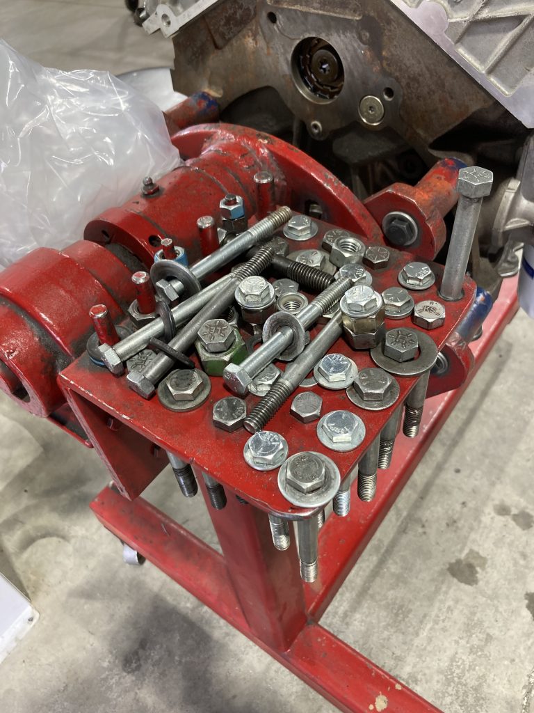 various engine bolts and hardware on organizer tray