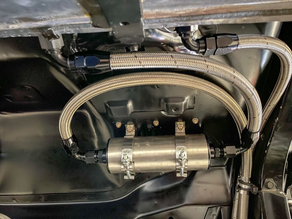 electric fuel pump installed under a vintage muscle car