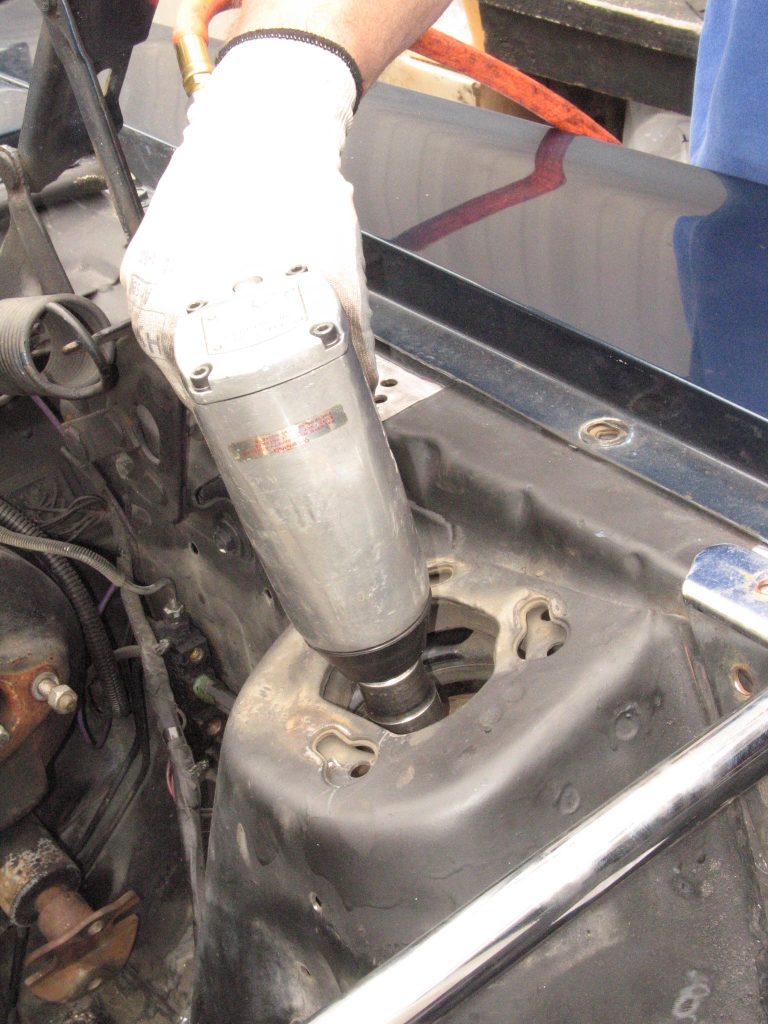 an impact gun being used inside a mustang shock tower