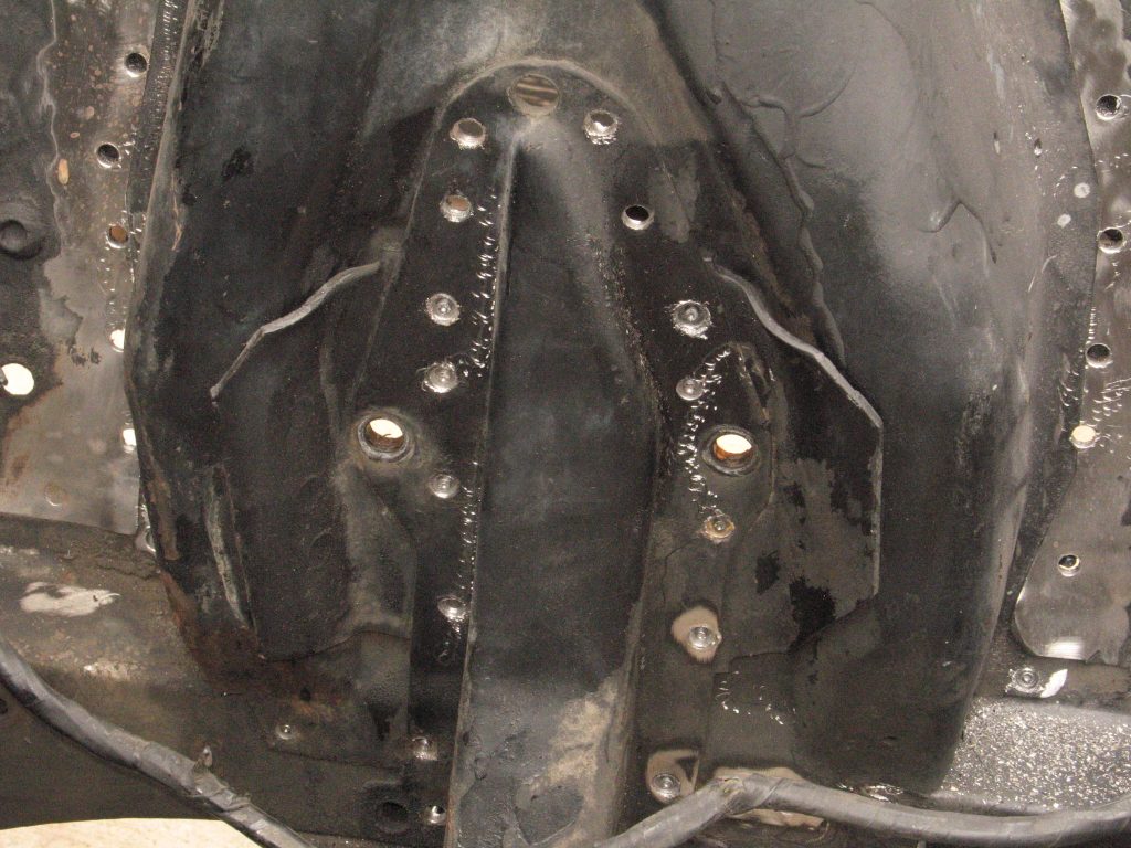 rusted ford mustang shock tower with welds removed