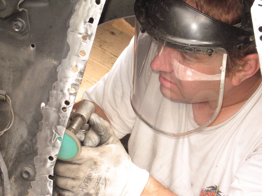 grinding Sheetmetal in a vintage ford mustang fender