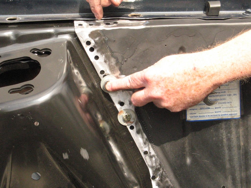 bolts temporarily holding a shock tower in place