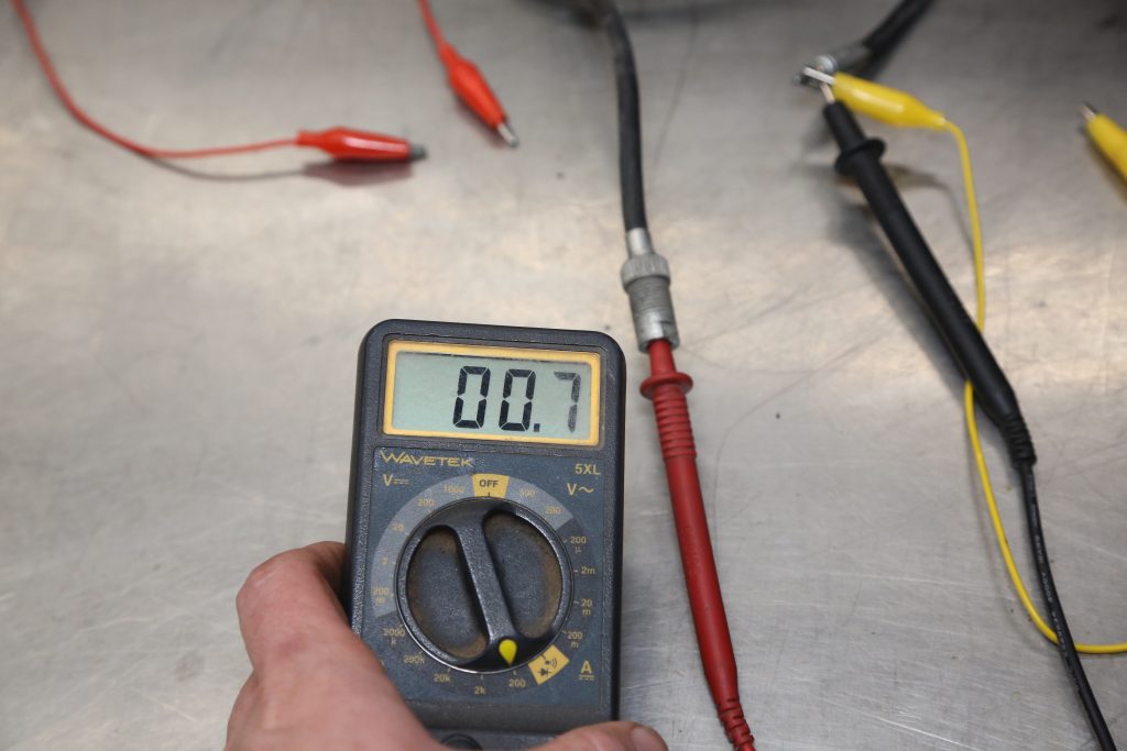 multimeter testing a radio antenna's resistance