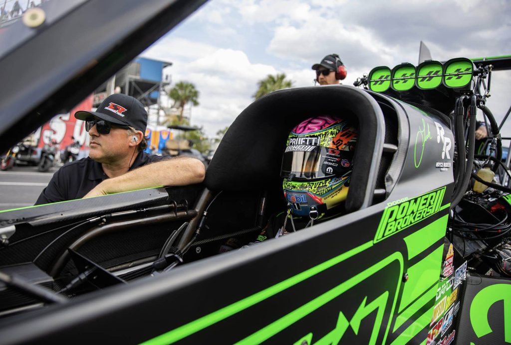 Tony Stewart alongside Leah Pruett in an nhra top fuel dragster