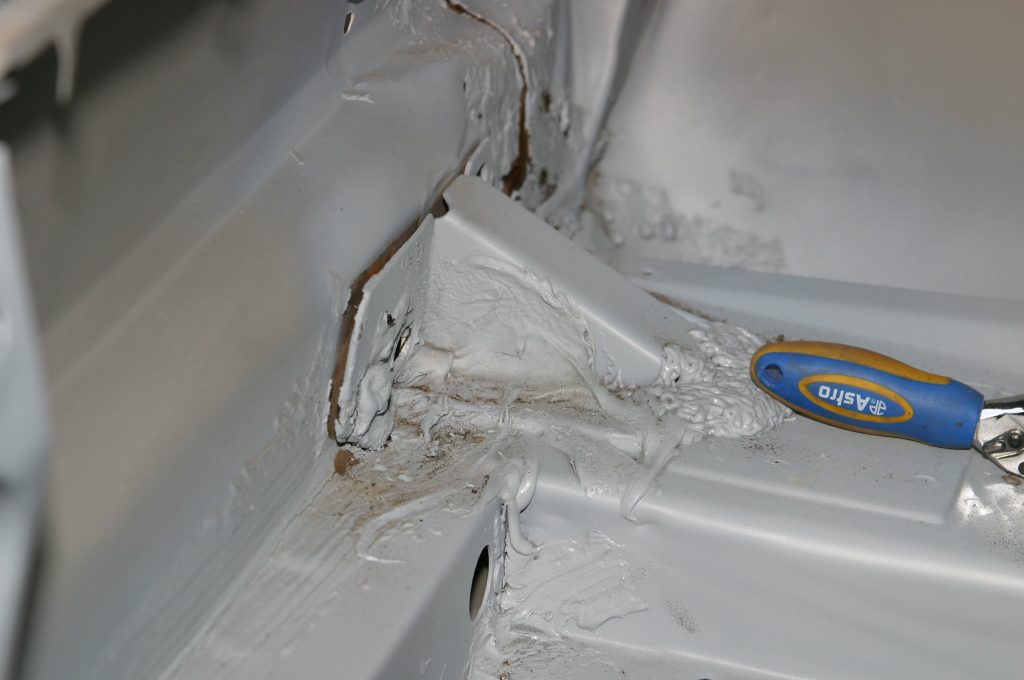 removing a metal bracket support from an old car body