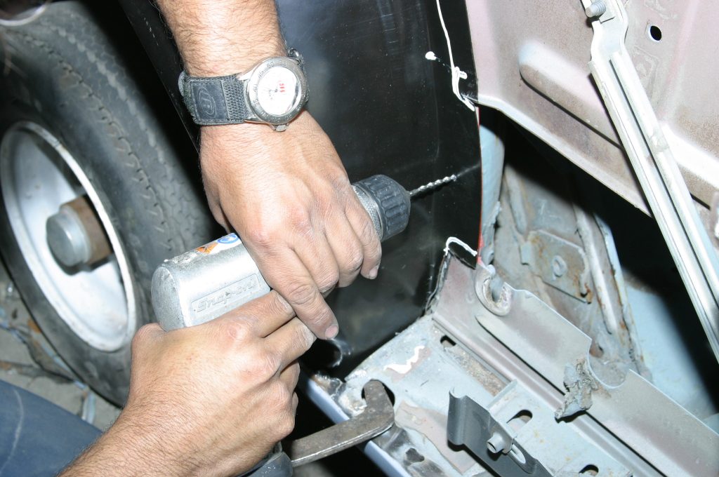drilling holes for a spot weld in an old car