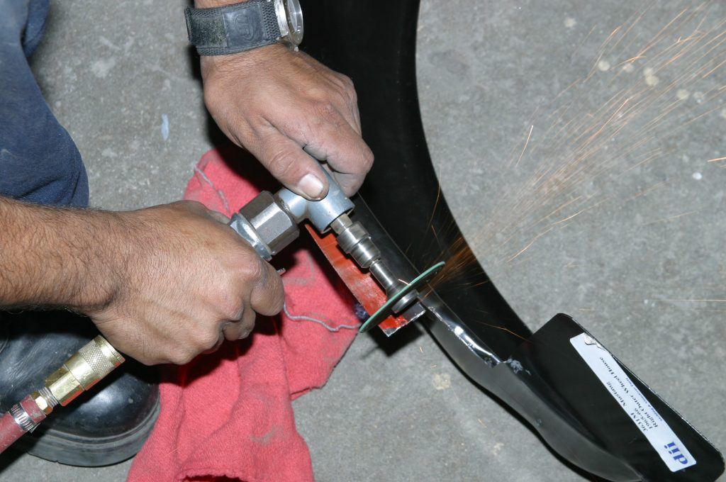 cutting a tab off of a replacement car fender