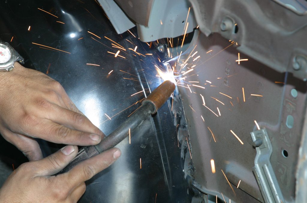 welding a fender liner into an old car body