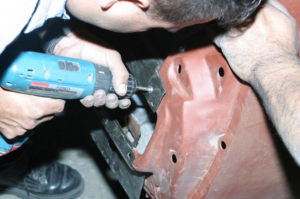 installing screws into a car body