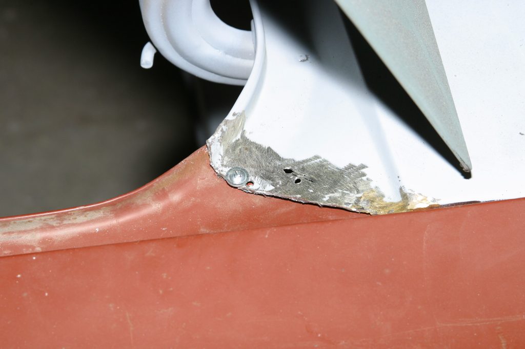 a screw installed to secure a body panel
