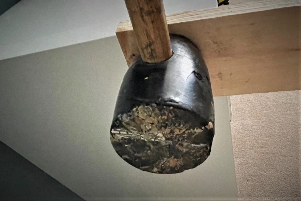 rubber mallet being used with wood to hammer a piece of furniture