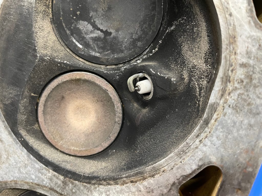long spark plug tip in a cylinder head combustion chamber