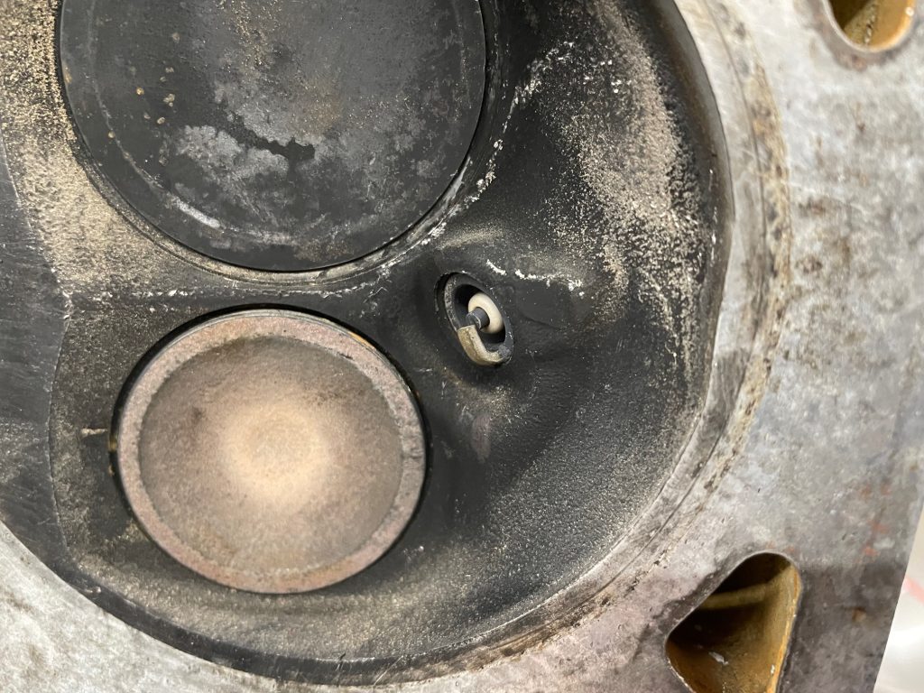 spark plug tip in a cylinder head combustion chamber