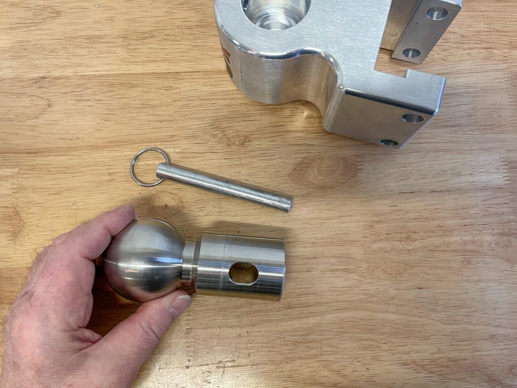 man holding a hitch ball