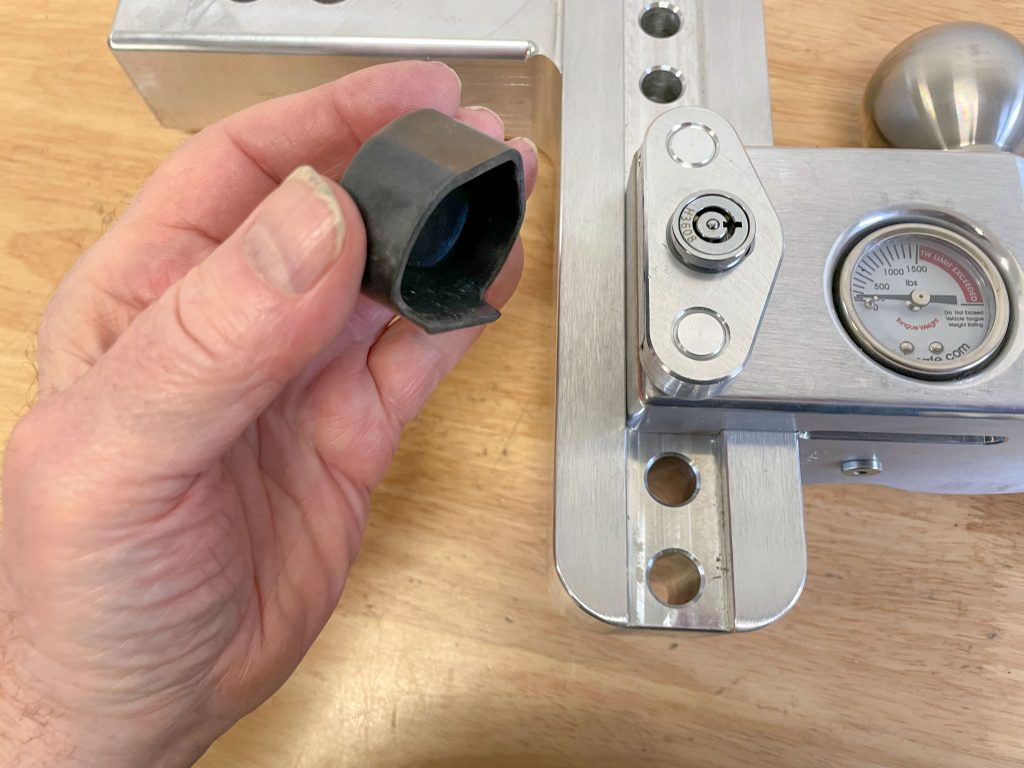 man holding rubber hitch cap