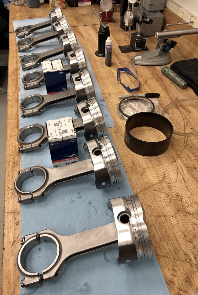 pistons and connecting rods arranged on a table