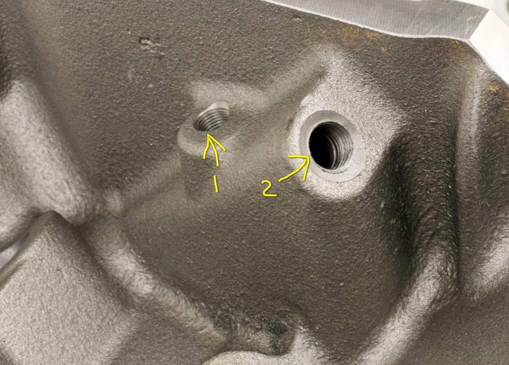numbered bolt holes in an engine block casting