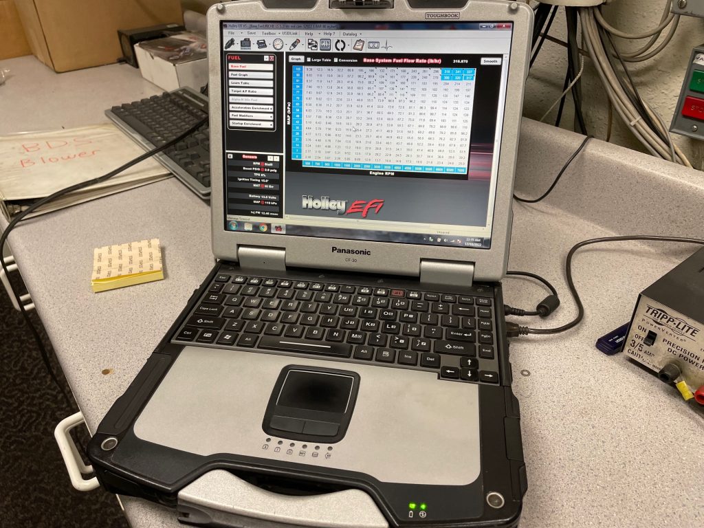 laptop in engine dyno displaying holley hp engine software