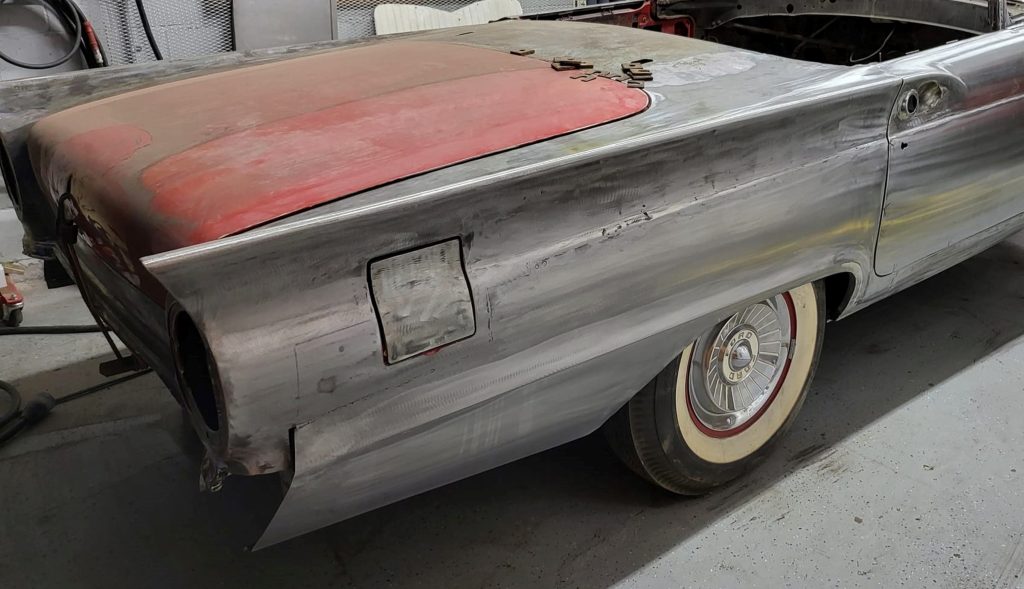 rear quarter of a 1957 thunderbird in bare metal
