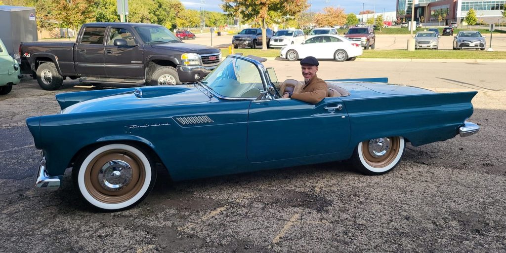 man sitting in a custom 1957 ford thunderbird