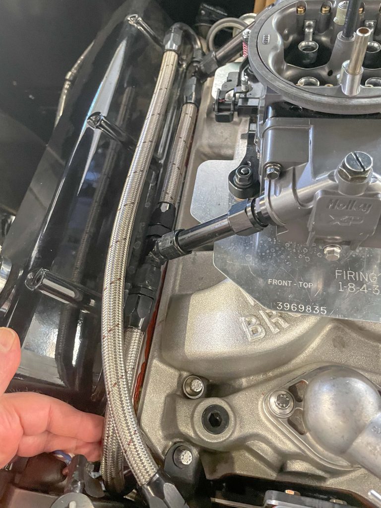 fuel lines inside a engine bay of a classic car