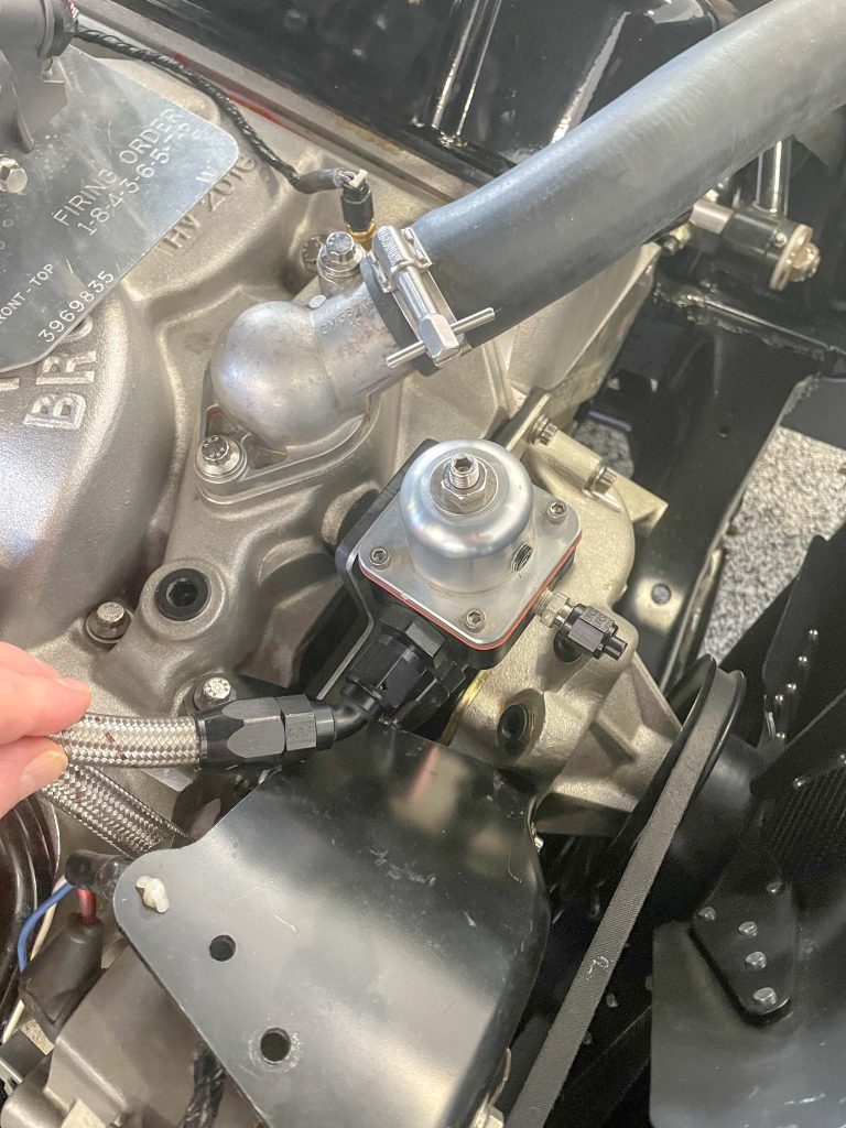 inserting a hose into a fuel pressure regulator