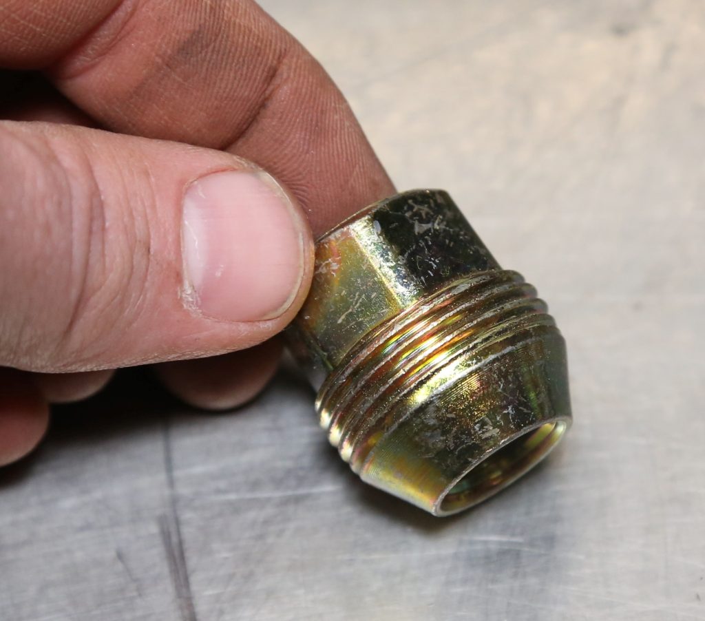 man holding a short shank lug nut
