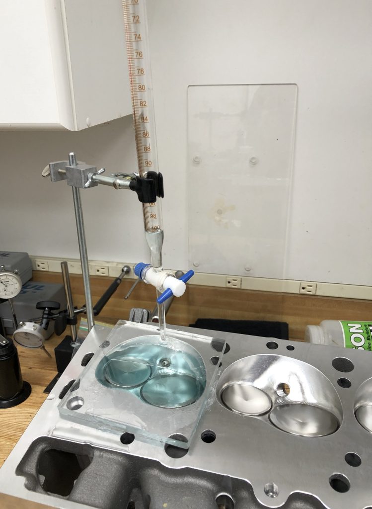 measuring combustion chamber volume with fluid