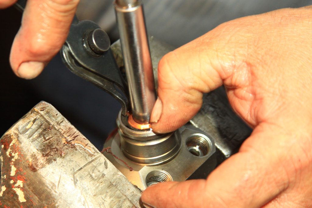 inserting a snap ring into a hydraulic cylinder