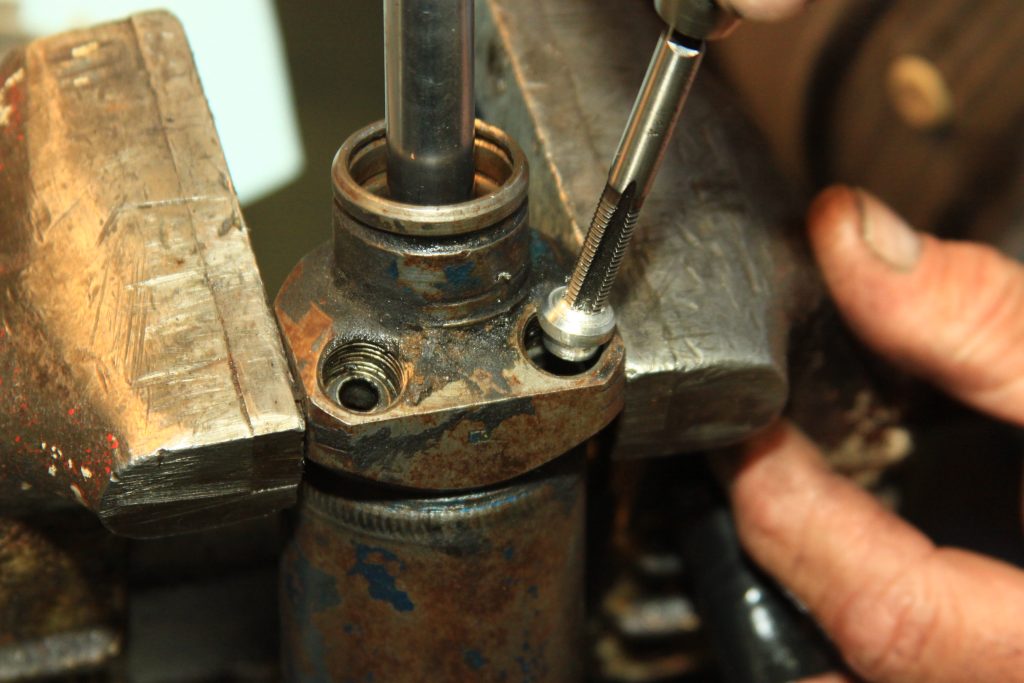 removing a threaded cap in an old car part