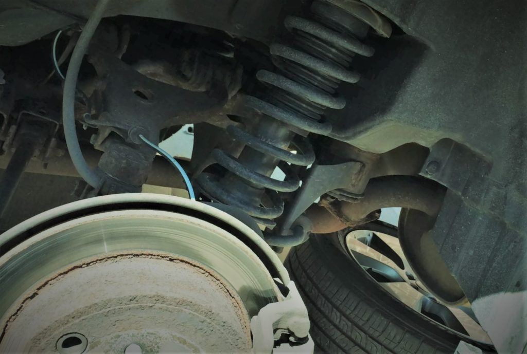 close up of old shock and strut in a wheel well