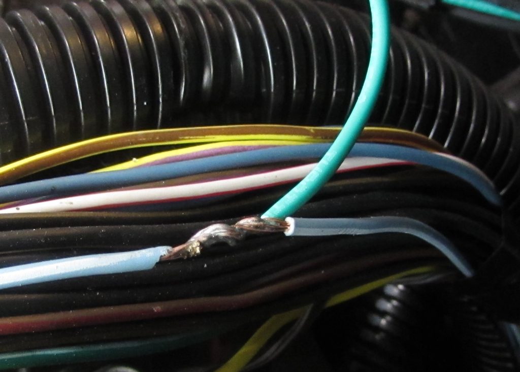 an exposed wire splice in a tight wire loom