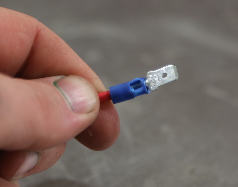 a spade terminal crimped on the end of a wire