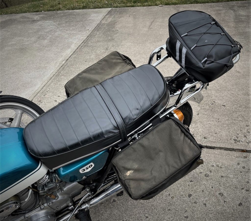 rear view of a honda cb350 with luggage rack, top bag and saddelbags