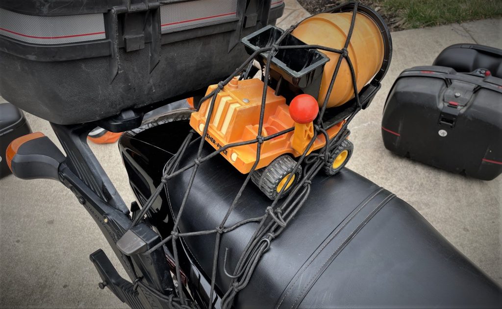 toy truck bungeed to seat of a motorcycle