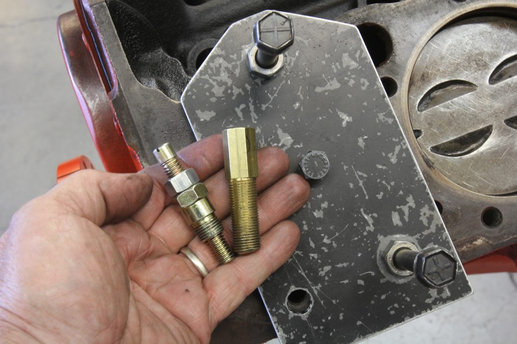 man holding a pair of fastener fittings
