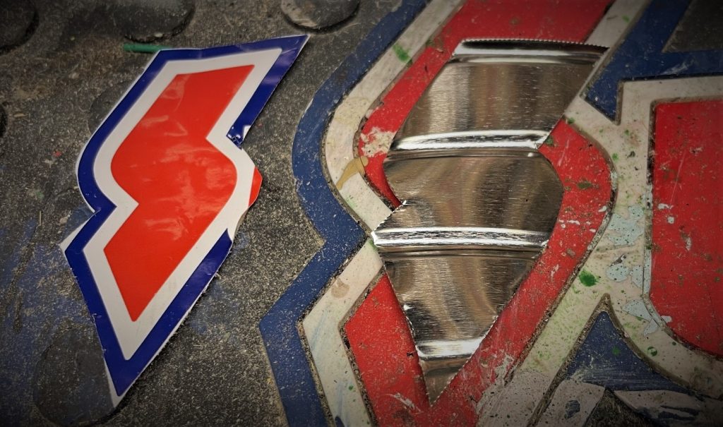 summit racing S logo cut out of metal
