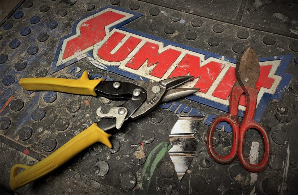 a pair of tin snips on a workbench