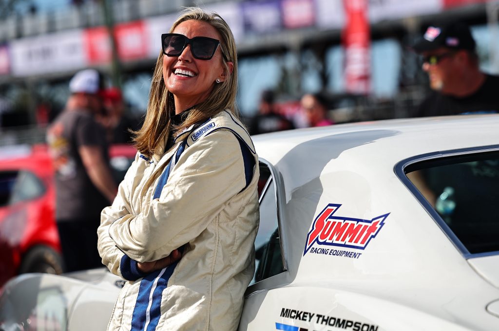 driver Leaning against a race car